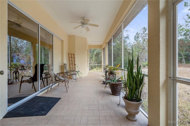 sunroom featuring ceiling fan