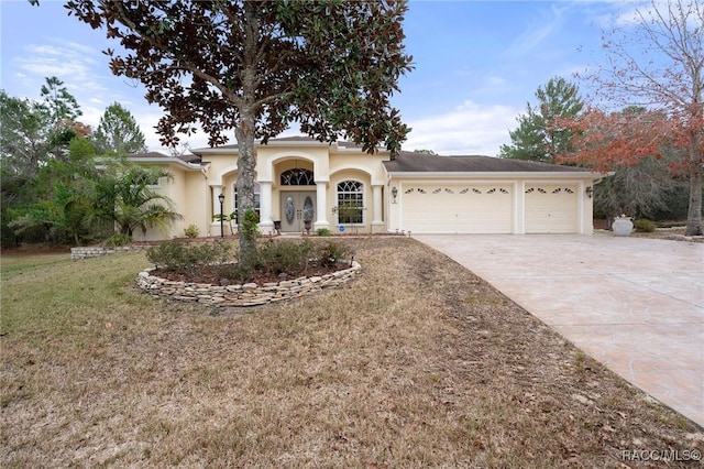 view of front of property with a front yard and a garage