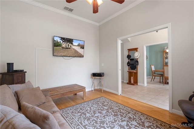 living room with ceiling fan, ornamental molding, and hardwood / wood-style floors