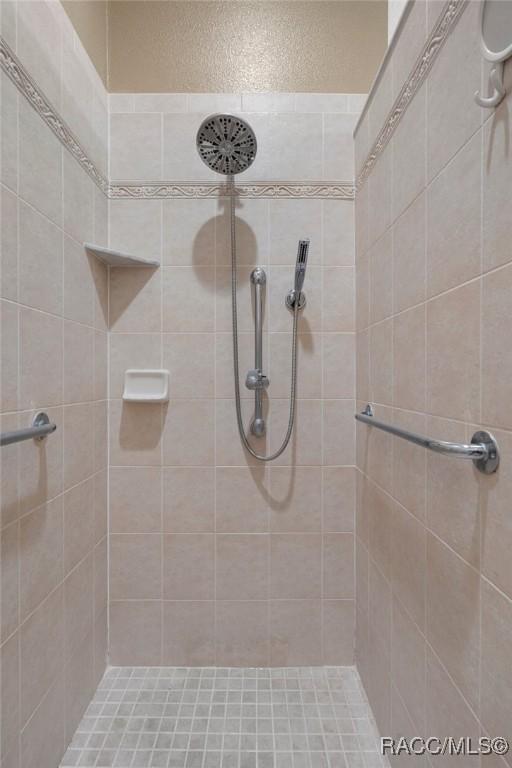 bathroom with tiled shower