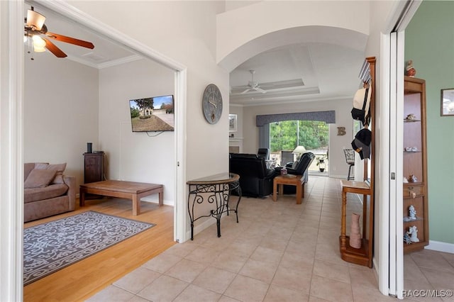 hall featuring ornamental molding and light hardwood / wood-style floors