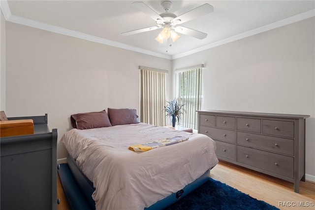 bedroom with ceiling fan, ornamental molding, and light wood-type flooring