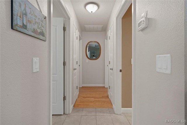 hallway with light tile patterned floors