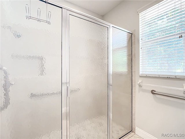 bathroom with a shower with door