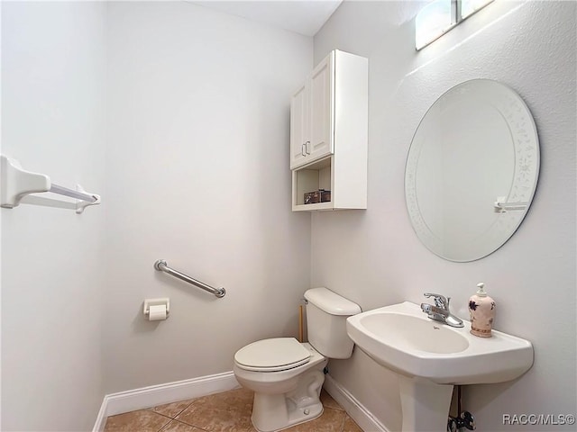 bathroom with sink, tile patterned floors, and toilet