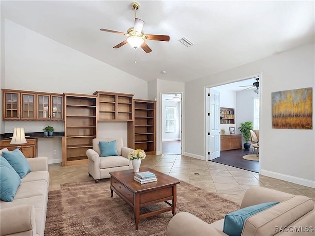 living room featuring baseboards, high vaulted ceiling, visible vents, and a ceiling fan