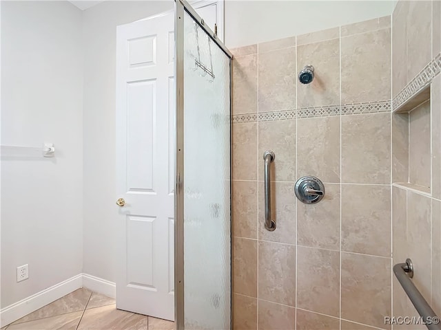 bathroom with a shower with door