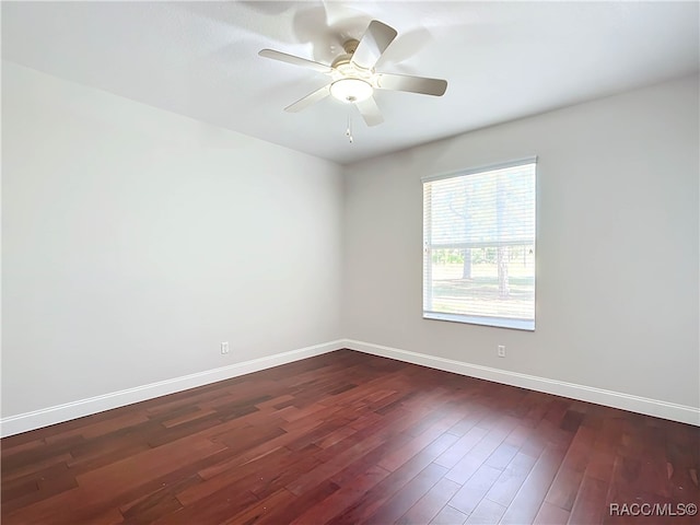 spare room featuring dark hardwood / wood-style floors and ceiling fan