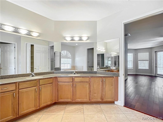 bathroom with vanity, tile patterned floors, and a healthy amount of sunlight