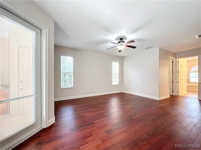 unfurnished room featuring ceiling fan and dark hardwood / wood-style flooring