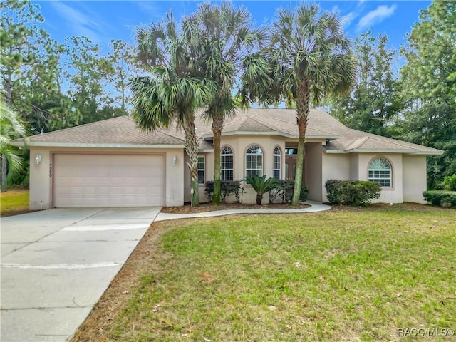 view of front of home featuring a garage and a front yard