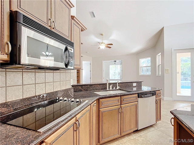 kitchen with decorative backsplash, stainless steel appliances, vaulted ceiling, ceiling fan, and light tile patterned floors