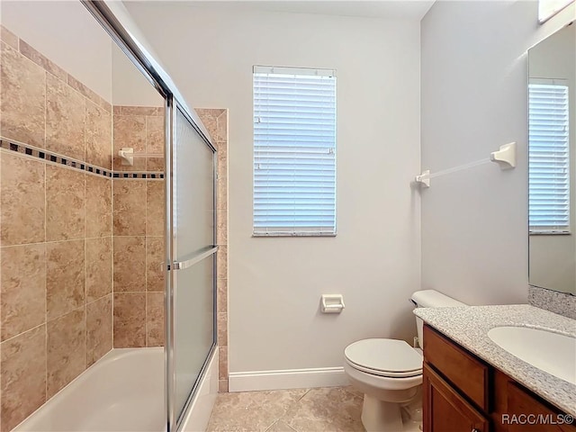 full bathroom featuring bath / shower combo with glass door, vanity, toilet, and tile patterned flooring