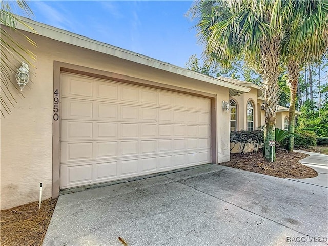 garage with concrete driveway