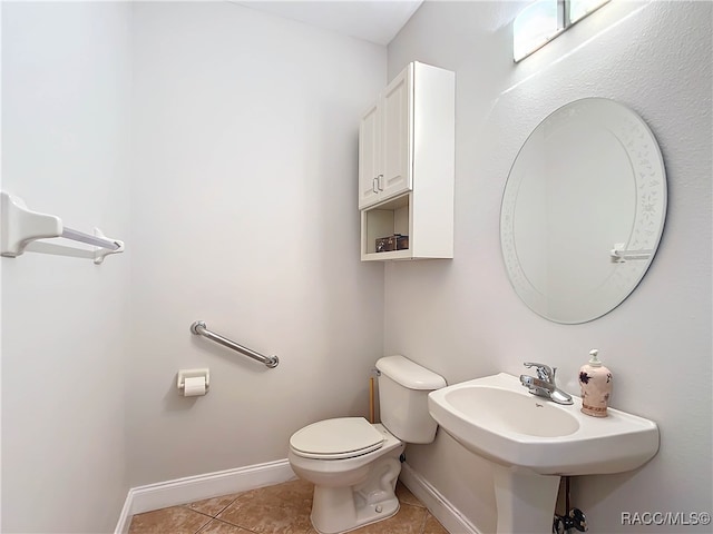 bathroom with tile patterned flooring and toilet