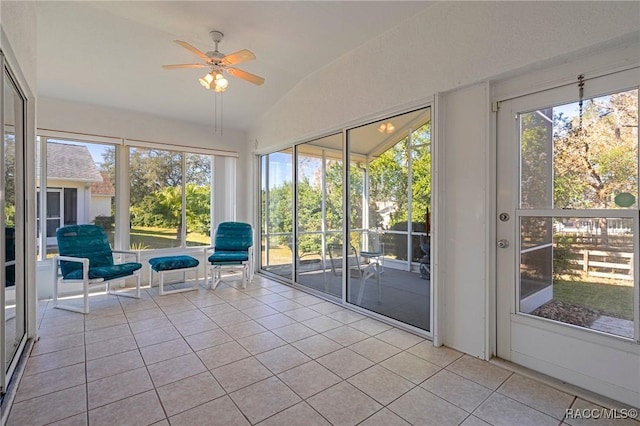 unfurnished sunroom featuring ceiling fan and vaulted ceiling