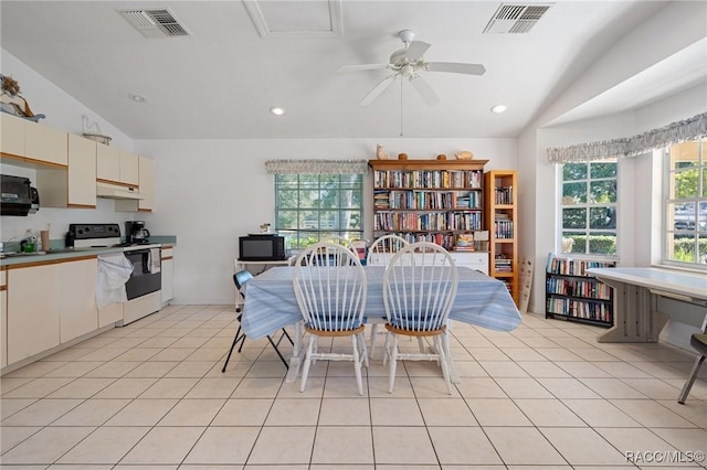 dining room featuring ceiling fan, light tile patterned flooring, and lofted ceiling