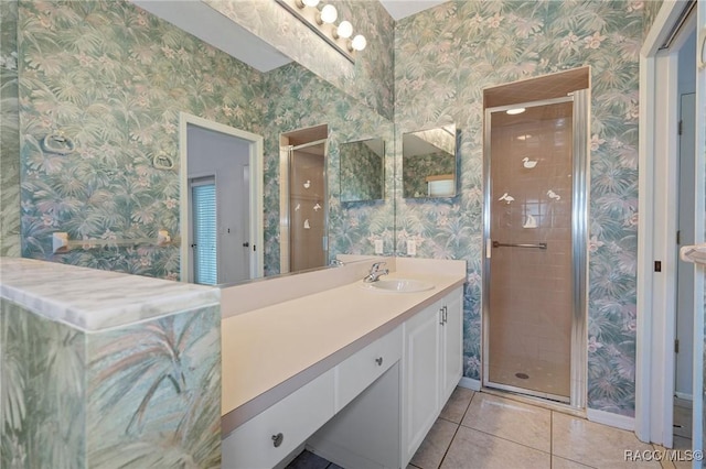 bathroom with tile patterned flooring, an enclosed shower, and vanity