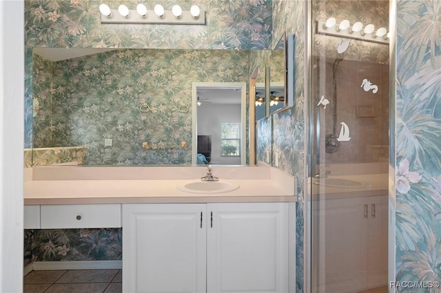 bathroom featuring vanity, tile patterned flooring, and a shower with door