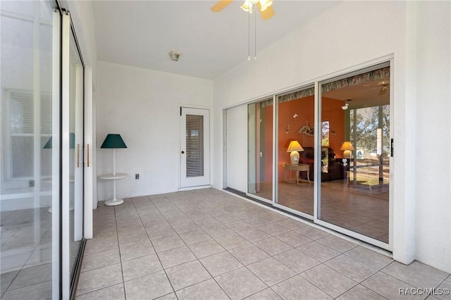 unfurnished sunroom with ceiling fan