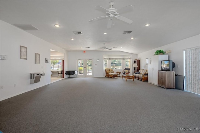 unfurnished living room with carpet floors, ceiling fan, french doors, and vaulted ceiling