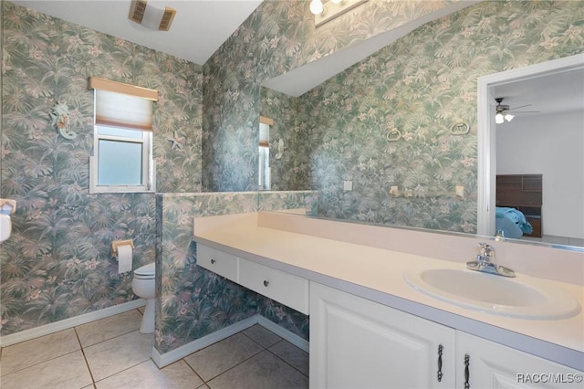 bathroom with ceiling fan, toilet, vanity, and tile patterned flooring