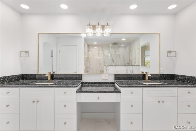 bathroom with vanity and a shower with door