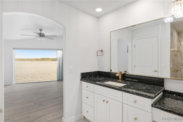 bathroom featuring hardwood / wood-style floors, ceiling fan, and vanity