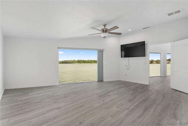 spare room featuring light hardwood / wood-style flooring, ceiling fan, and lofted ceiling