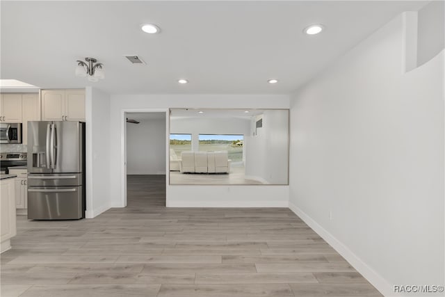 kitchen featuring light hardwood / wood-style flooring and appliances with stainless steel finishes