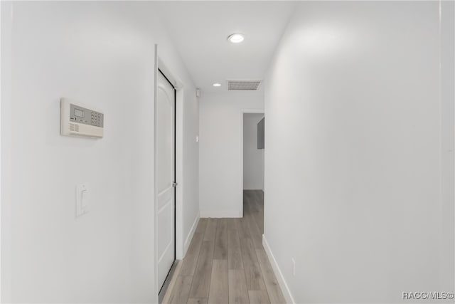 hallway with light hardwood / wood-style flooring