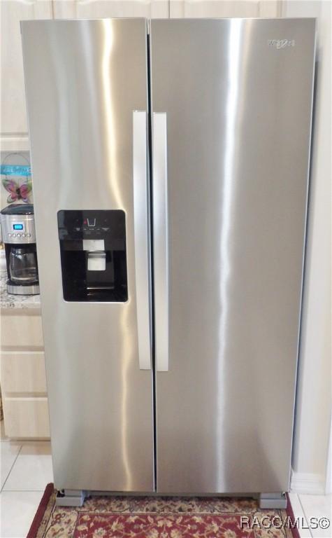 room details with stainless steel fridge with ice dispenser and light countertops