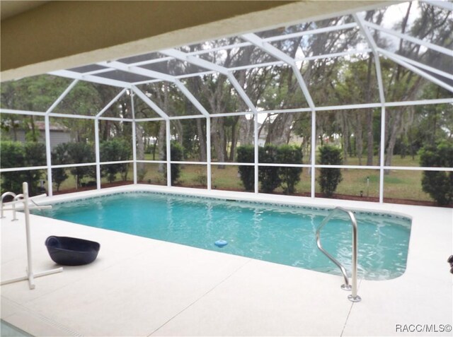 outdoor pool featuring a lanai and a patio area
