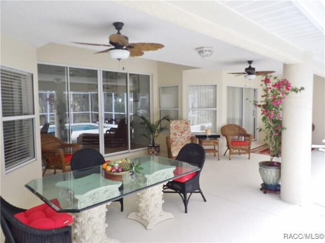 view of patio featuring ceiling fan and outdoor dining space