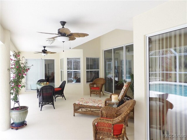 sunroom / solarium with vaulted ceiling and carpet floors
