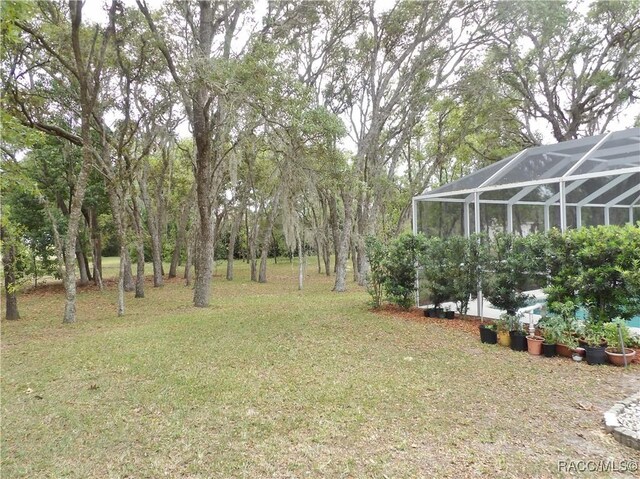view of yard featuring glass enclosure