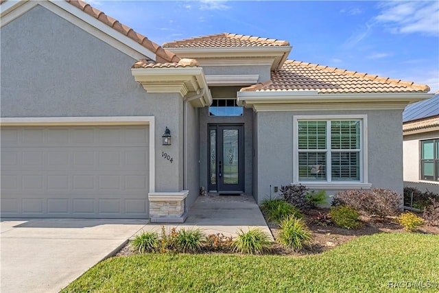 view of exterior entry with a garage