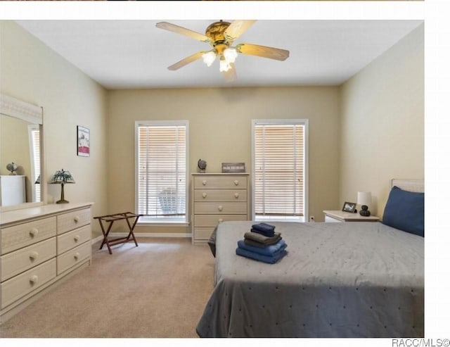 carpeted bedroom featuring ceiling fan