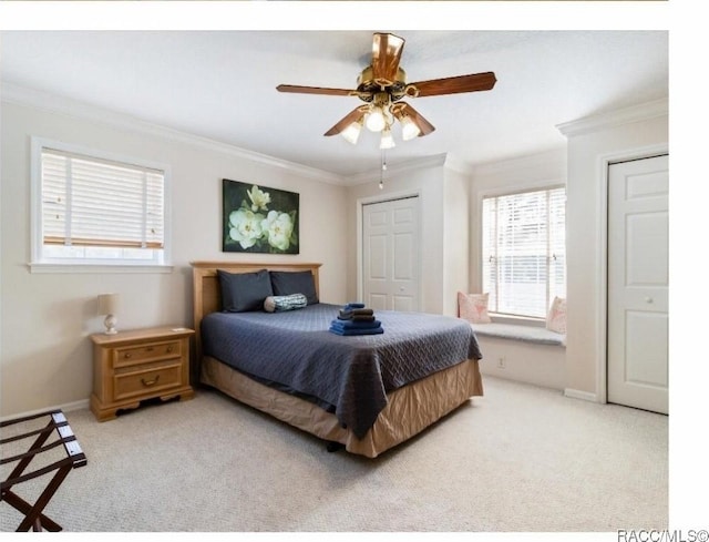 carpeted bedroom with crown molding and ceiling fan