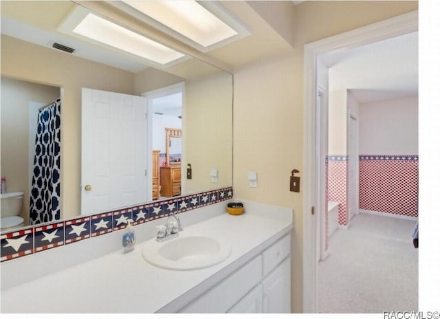 bathroom with vanity and toilet