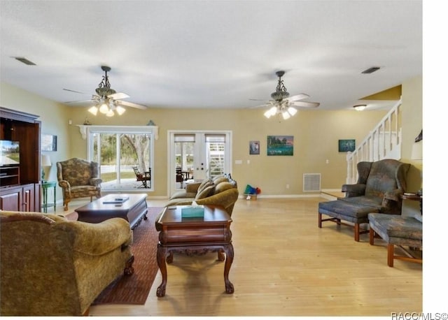 living room with ceiling fan, light hardwood / wood-style floors, and french doors