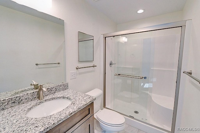 bathroom featuring vanity, toilet, and walk in shower