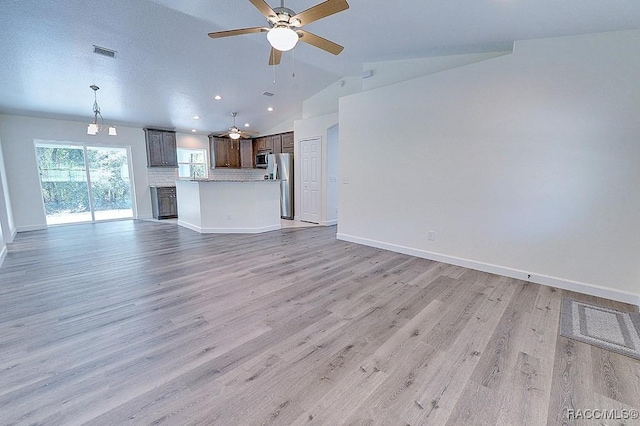 unfurnished living room with lofted ceiling, ceiling fan, and light wood-type flooring