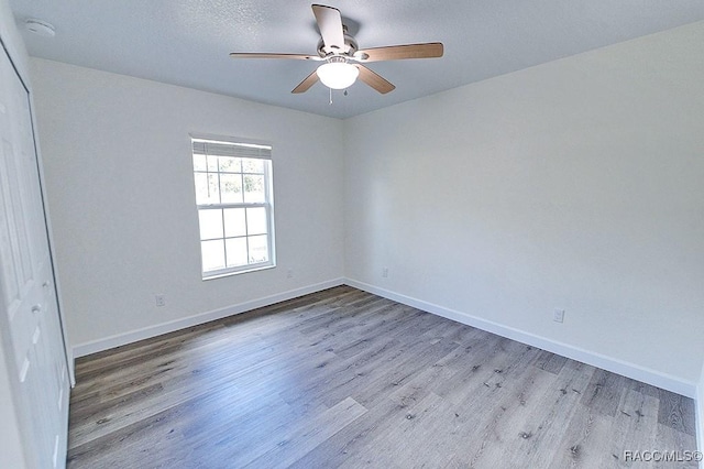 spare room featuring light hardwood / wood-style floors and ceiling fan