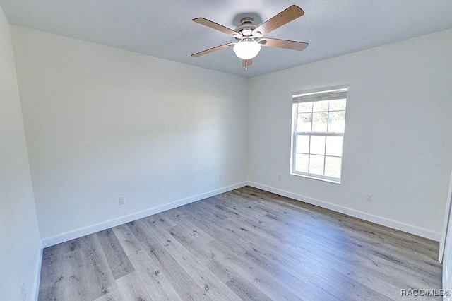 spare room with ceiling fan and light wood-type flooring