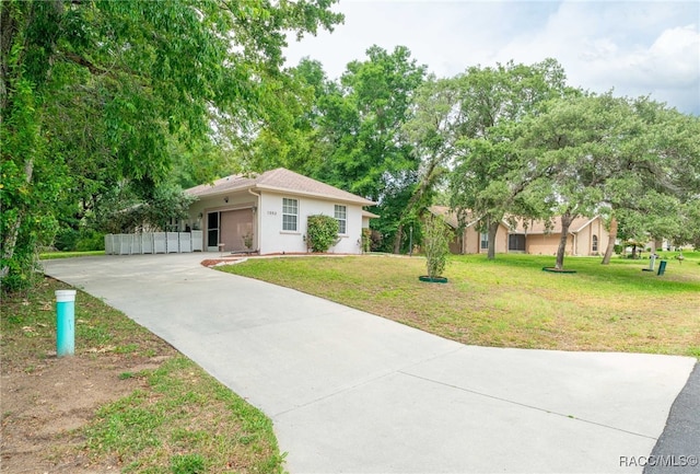 1553 E Pacific Ln, Inverness, FL 34453 - ranch-style house with concrete driveway, a front yard, and stucco siding
