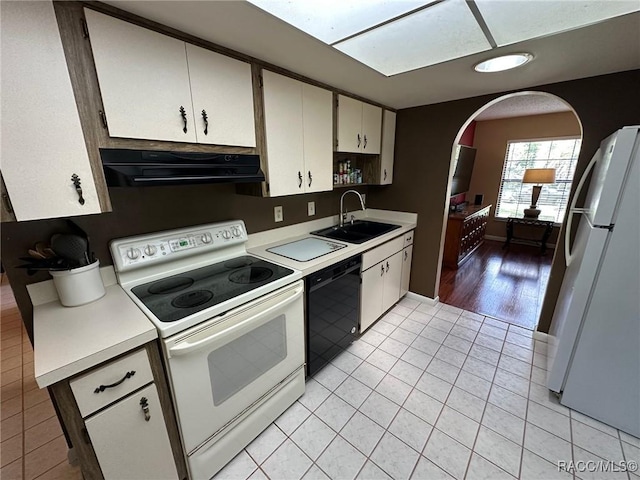 2510 W Dolphin Dr, Citrus Springs, FL 34434 - kitchen featuring white appliances, extractor fan, light countertops, light tile patterned floors, and white cabinetry