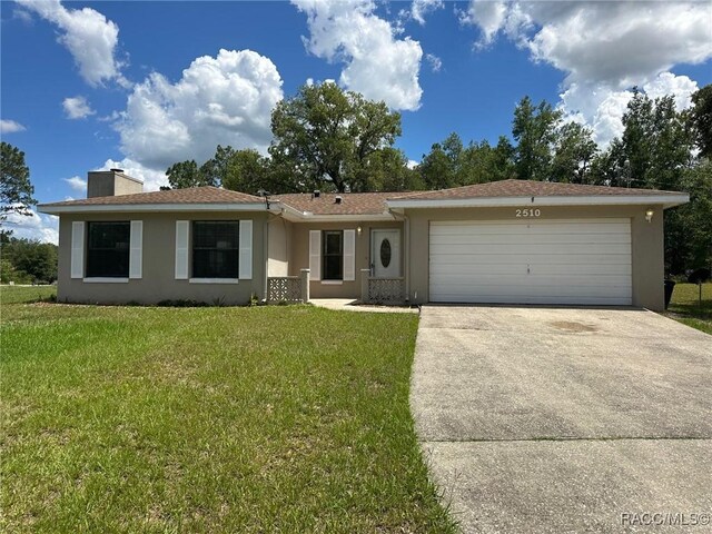 2510 W Dolphin Dr, Citrus Springs, FL 34434 - ranch-style house featuring stucco siding, an attached garage, concrete driveway, a chimney, and a front yard