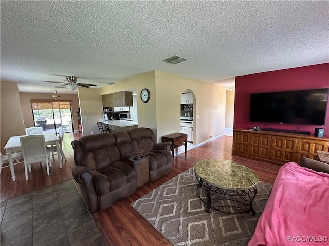 2510 W Dolphin Dr, Citrus Springs, FL 34434 - living area with arched walkways, wood finished floors, a textured ceiling, and ceiling fan