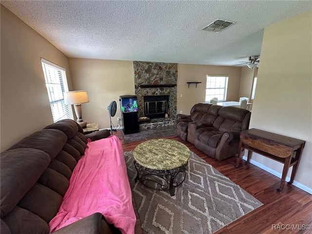 2510 W Dolphin Dr, Citrus Springs, FL 34434 - living room featuring wood finished floors, a textured ceiling, and a fireplace